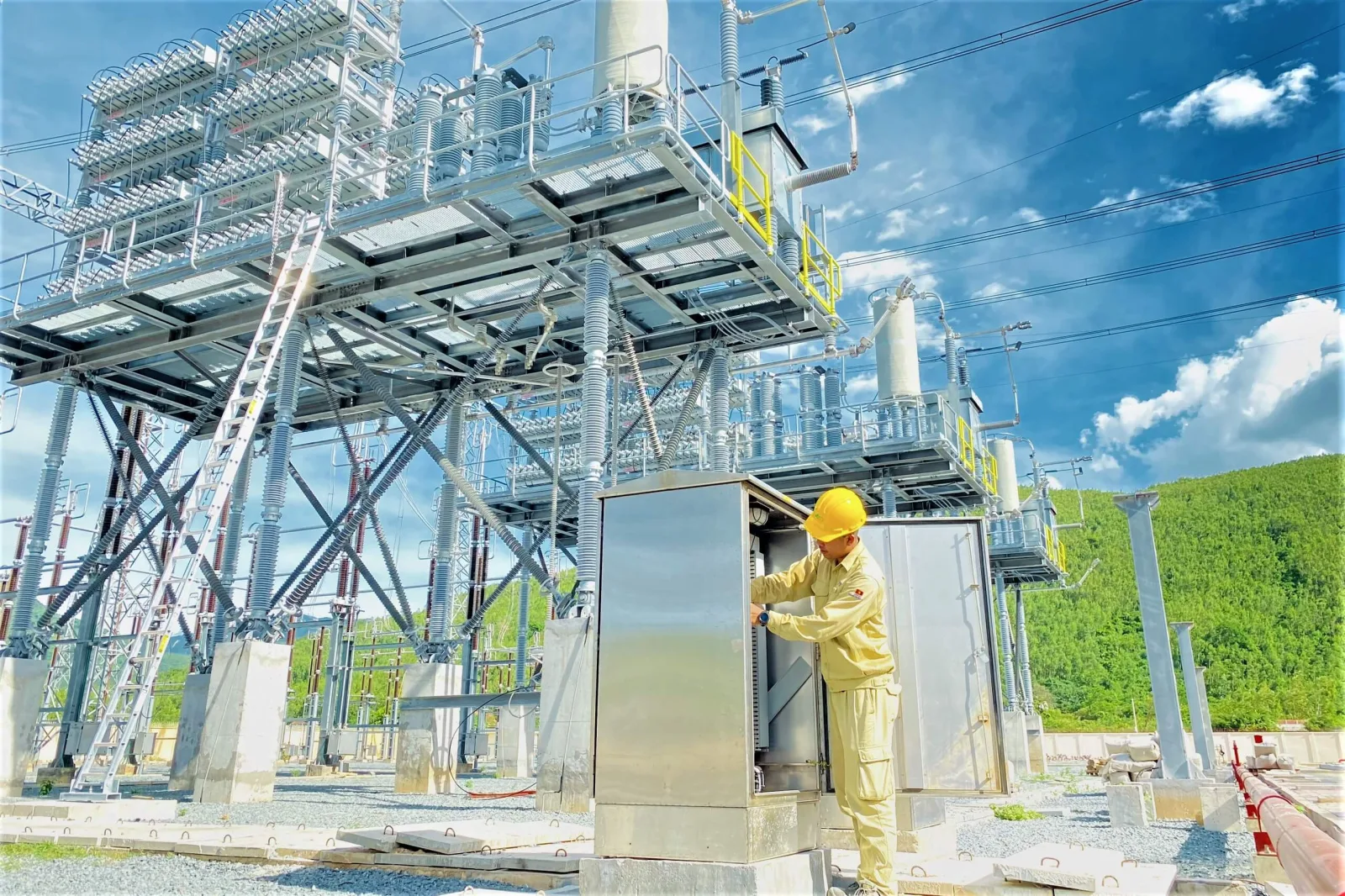Engineer at a control cabinet in a 500 kV substation