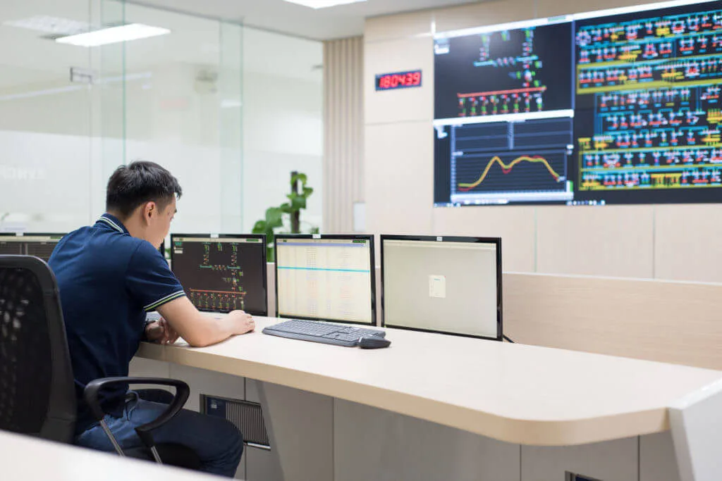 Operator monitoring a control room display wall